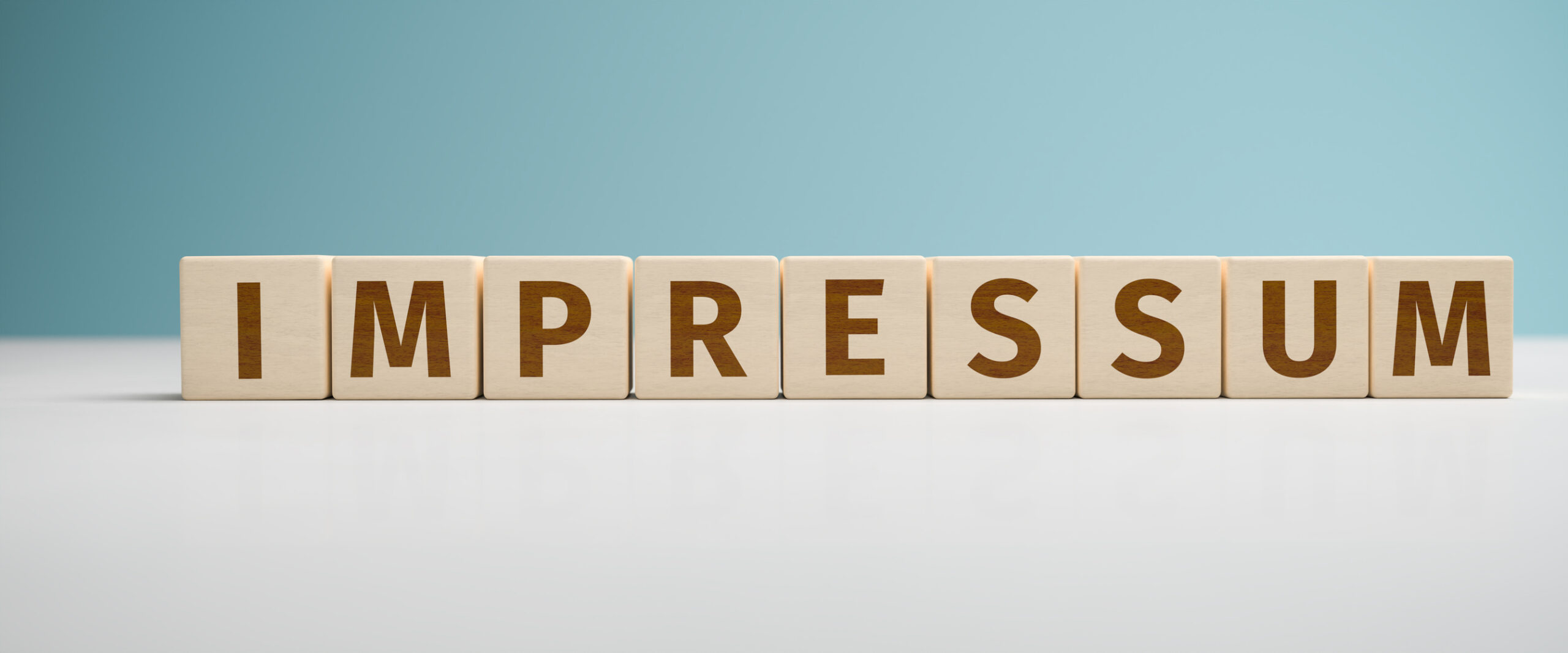"Impressum" web banner - the German word Impressum built from letters on wooden cubes for the use as a web banner.
